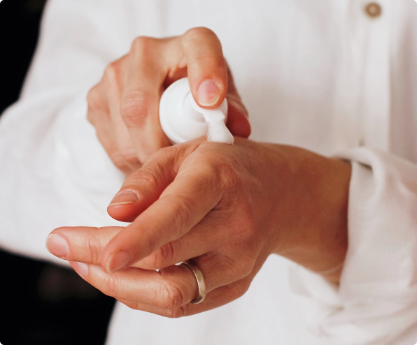 person applying a cleansing foam skincare product to their hands