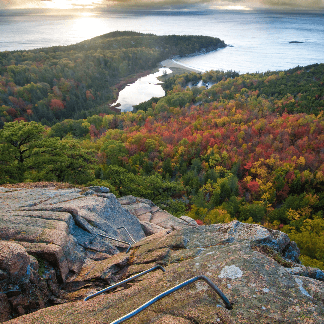 Hiker applying no rinse cleansing foam on Acadia's Beehive Trail, ensuring cleanliness without water.