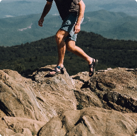 person hiking on top of a mountain